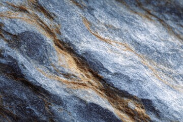 Fototapeta premium Greyblue stone with gold veins crossing diagonally across a textured surface