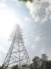 Low-angle shot of an Ultra High Voltage Power Line tower. An electrical distribution tower with...