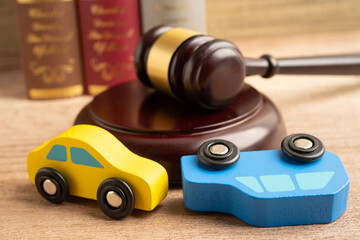 Hammer gavel judge with car vehicle accident, insurance coverage claim lawsuit court case.