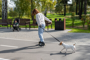 Caucasian woman roller skating with her jack russell terrier dog in park. 