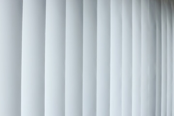 Full Frame Of Pristine White Vertical Blinds, Creating Pattern Of Light And Shadow