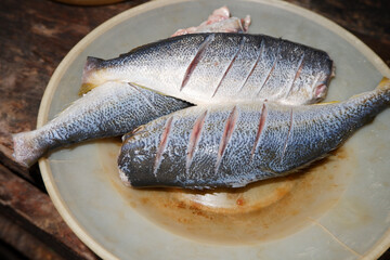 fresh raw fish on a kitchen plate