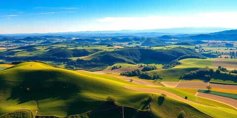 Vast, sun-drenched summer landscape panorama; rolling hills, lush fields, blue sky, distant mountains,  sunny,  art