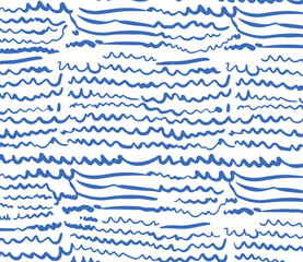 Obraz premium Seamless pattern of blue scribbled waves and lines on a white background