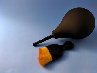 Air Blower and Cleaning Brush for Camera and Electronics – Isolated on Blue Background