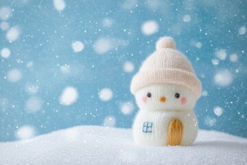 A cute little house made of white yarn, with snow on the roof and a blue background