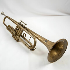 Obraz premium Vintage brass trumpet with worn finish, isolated on white background.