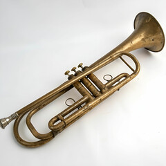 Fototapeta premium Vintage brass trumpet with worn finish, isolated on white background.