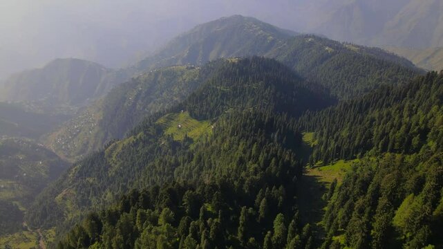 Aerial view of mountains and forests in a serene valley, Pakistan.