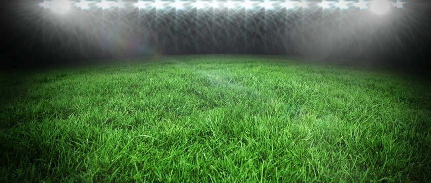 Flat design showing green grass turf glowing under row of floodlights in open-air night stadium