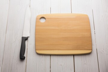 Kitchen knife and chopping board on wooden floor © vectorfusionart