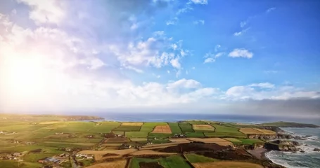 Schilderijen op glas flat design showing farmland with barns meeting rocky coast calm sea under streaming sunlight © vectorfusionart