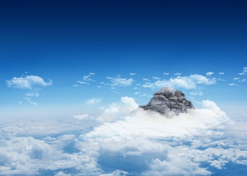 Fototapeta Mountain peak through clouds