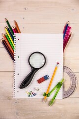 Presenting blank lined notebook in flat design on tabletop with magnifying glass and drawing tools