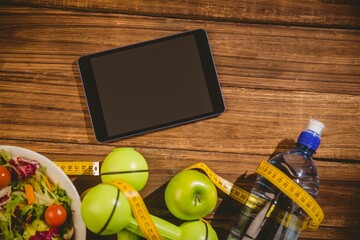 High angle view of apples and digital tablet on table
