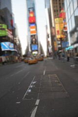 Flat design is showing city avenue with yellow taxis, utility plate, digital billboards