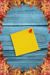 Autumn leaves with yellow note