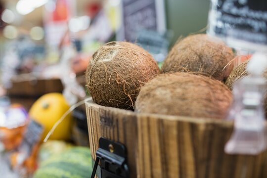 Coconuts in container at supermarket