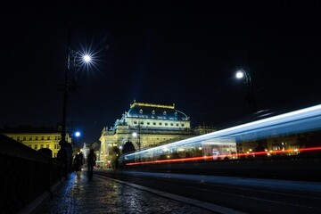 Displaying nighttime bridge in flat design featuring illuminated domed building, tram light trails