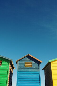 Fototapeta Low angle view of colorful beach hut against sky