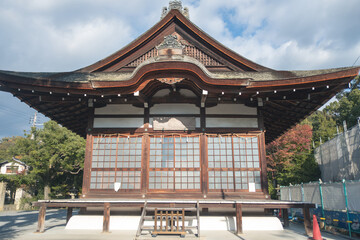 Uji Shrine at Uji, Kyoto, Japan, Traditional Japanese temple architecture under a cloudy sky.
