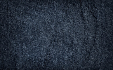 Dark grey stone or black slate stone texture background .