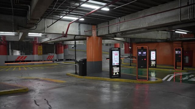 Jakarta, Indonesia - June &lrm;5, &lrm;2025: Automatic parking exit gate at Central Park Mall located in the building parking area with illuminated barriers and modern payment machines.