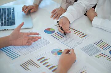 Businesspeople evaluate project efficiency and financial figures with business team for marketing...