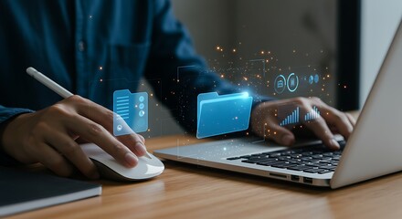 Person organizing digital files and data using a laptop and mouse