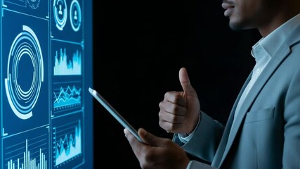 A businessman giving a thumbs up while interacting with a digital screen displaying data analytics and futuristic interfaces, symbolizing success in technology - Powered by Adobe