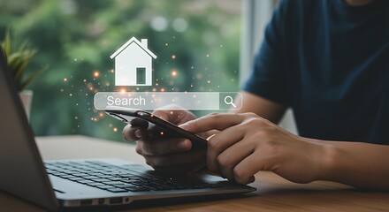 Person searching for a house online using a smartphone and laptop