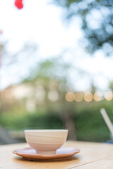 Close up of white bowl on the table with bokeh background