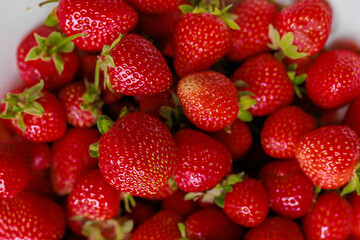 Fresh sweet strawberries in a white bowl . Seasonal berries.