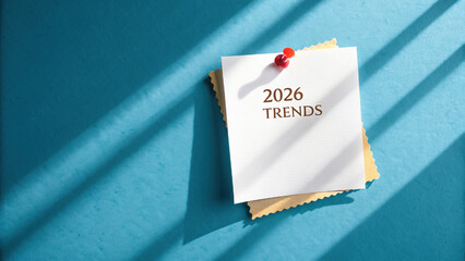 2026 trends note pinned on blue background with shadows creating modern aesthetic