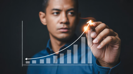 Businessman drawing growth chart with marker, showcasing success and progress. 2026