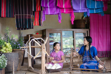 Beautiful Young Women Learning Traditional Karen Weaving in Chiang Mai, Thailand.