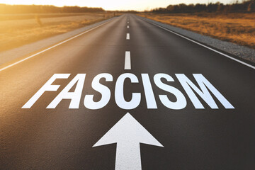 Street with white word 'Fascism' and arrow written on it. Concpet for countries turning more and more towards fascism.