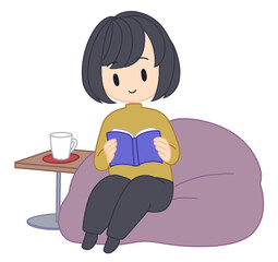 クッションに座って本を読む女性