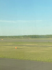Airport Runway and Grassy Field Under Clear Blue Sky
