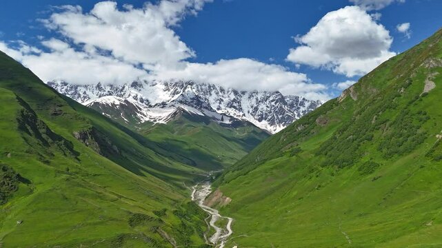 Timelapse of Shkhara Mountain, Winding Road, Inguri River and Moving Clouds in Ushguli, Georgia