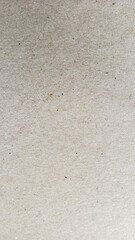 Close-up of recycled textured brown paper background with natural fiber details