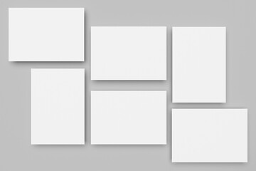 Fototapeta premium White A4 paper, magazine, or business card mockups floating diagonally with soft shadows isolated on grey background.