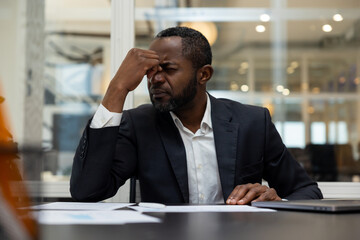African american businessman having a headache after a busy working day