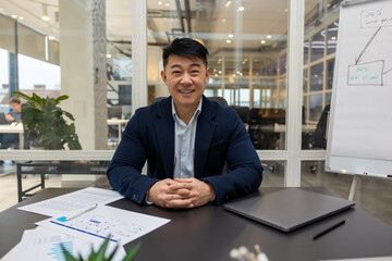 Asian young businessman working in his office and looking busy