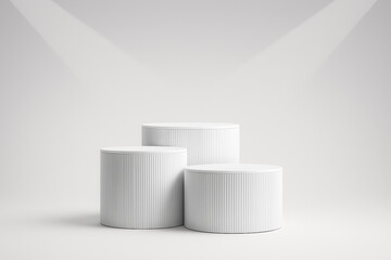 Three white cylindrical podiums are arranged on a plain white background, ready for presentation