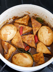Cooking semur, Indonesian traditional food, with tofu and quail eggs