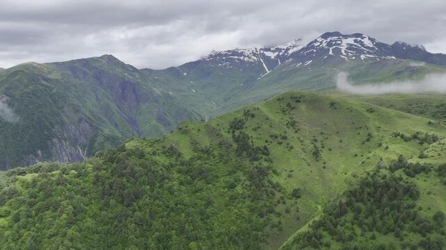 Aerial view of foggy Caucasus mountains near Koruldi Lake in Mestia, Georgia on a cloudy day