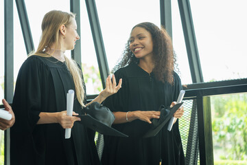 Happy Diverse Graduates Holding Diplomas, Young Women in Graduation Gowns and Caps, Smiling Female Graduates with Certificates, University Celebration