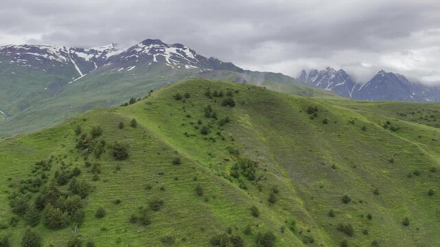 Aerial view of foggy Caucasus mountains near Koruldi Lake in Mestia, Georgia on a cloudy day