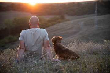 Happy dog and man playing outdoor